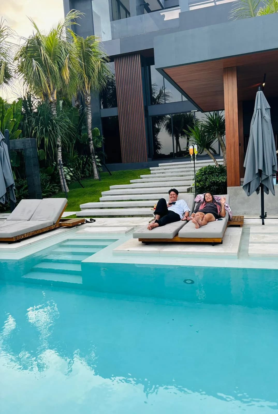 a cople having iv drips by the pool side